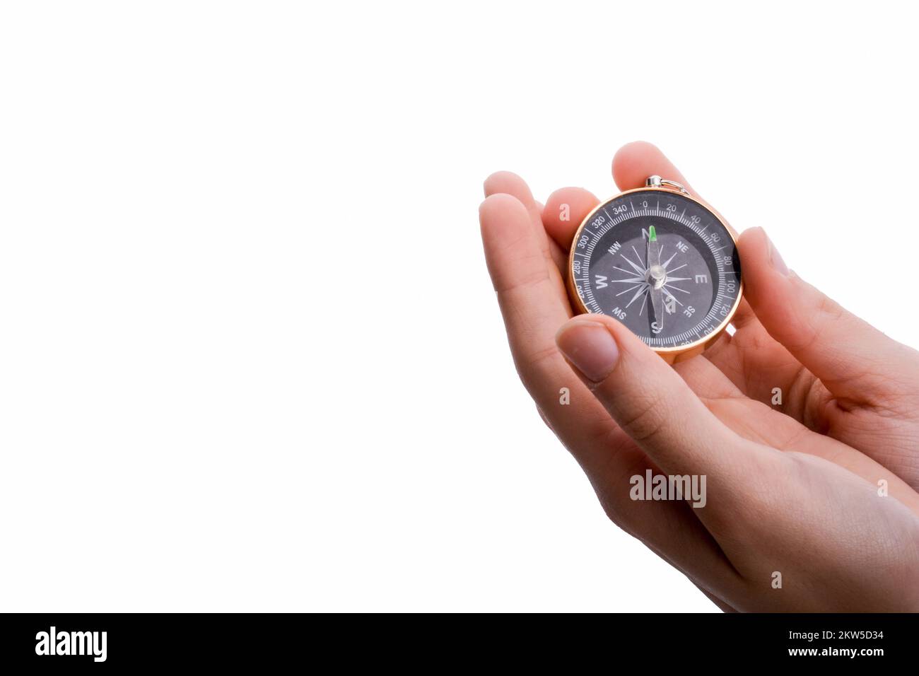Isolated compass in child's hand on a white background Stock Photo