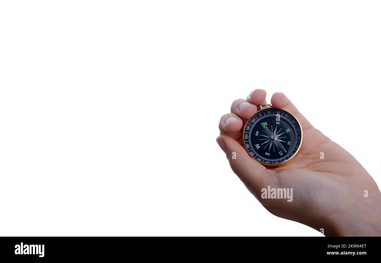 Isolated compass in child's hand on a white background Stock Photo