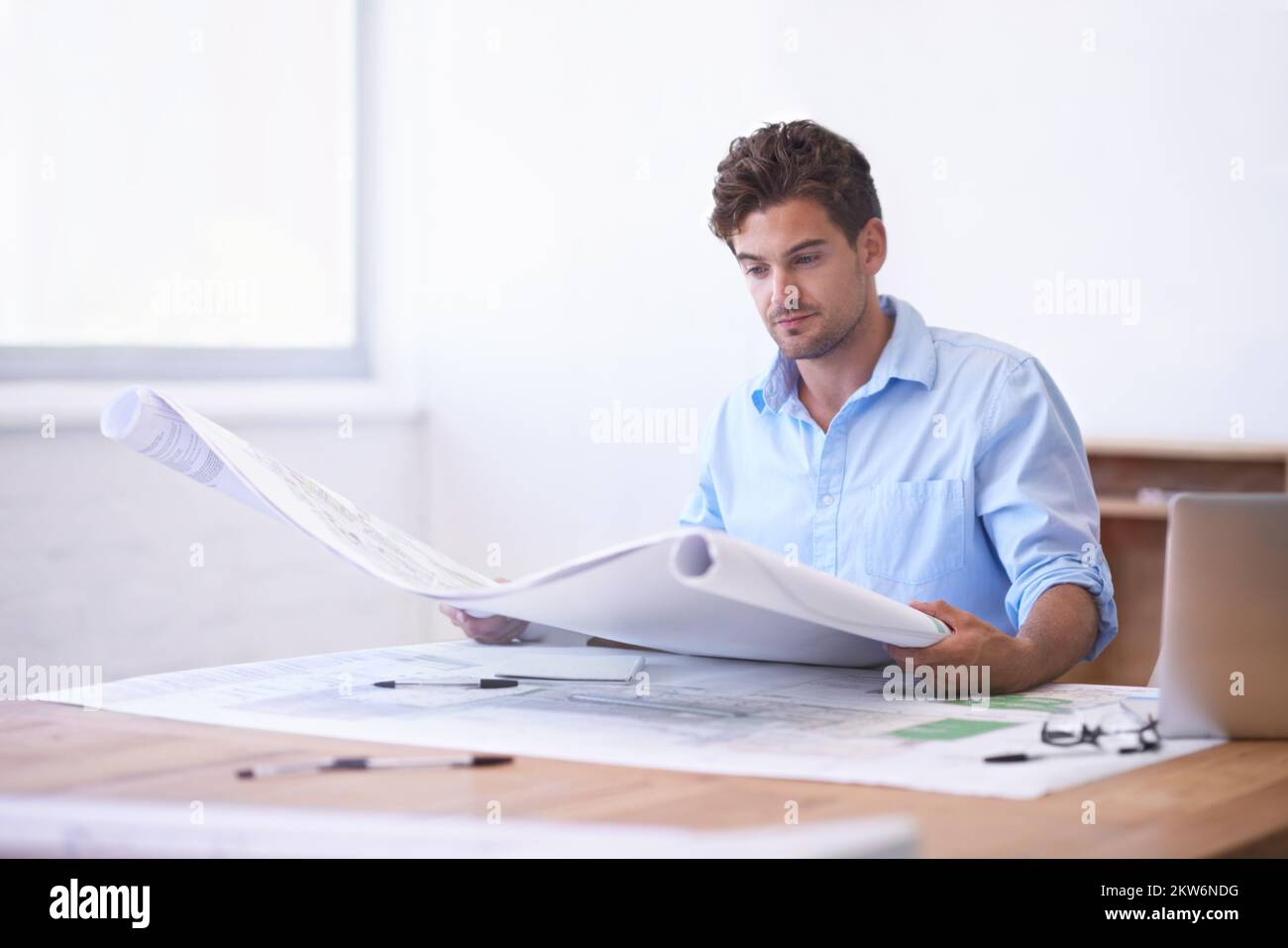 Designing the perfect building. an attractive male architect working in