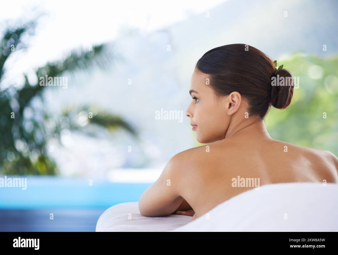 Views to help you take your mind off...everything. A young woman relaxing in a health spa. Stock Photo
