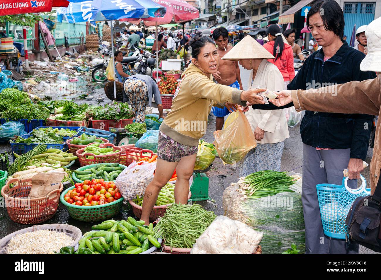 Vietnamese trader working in street market, central Ho Chi Minh City, Vietnam Stock Photo
