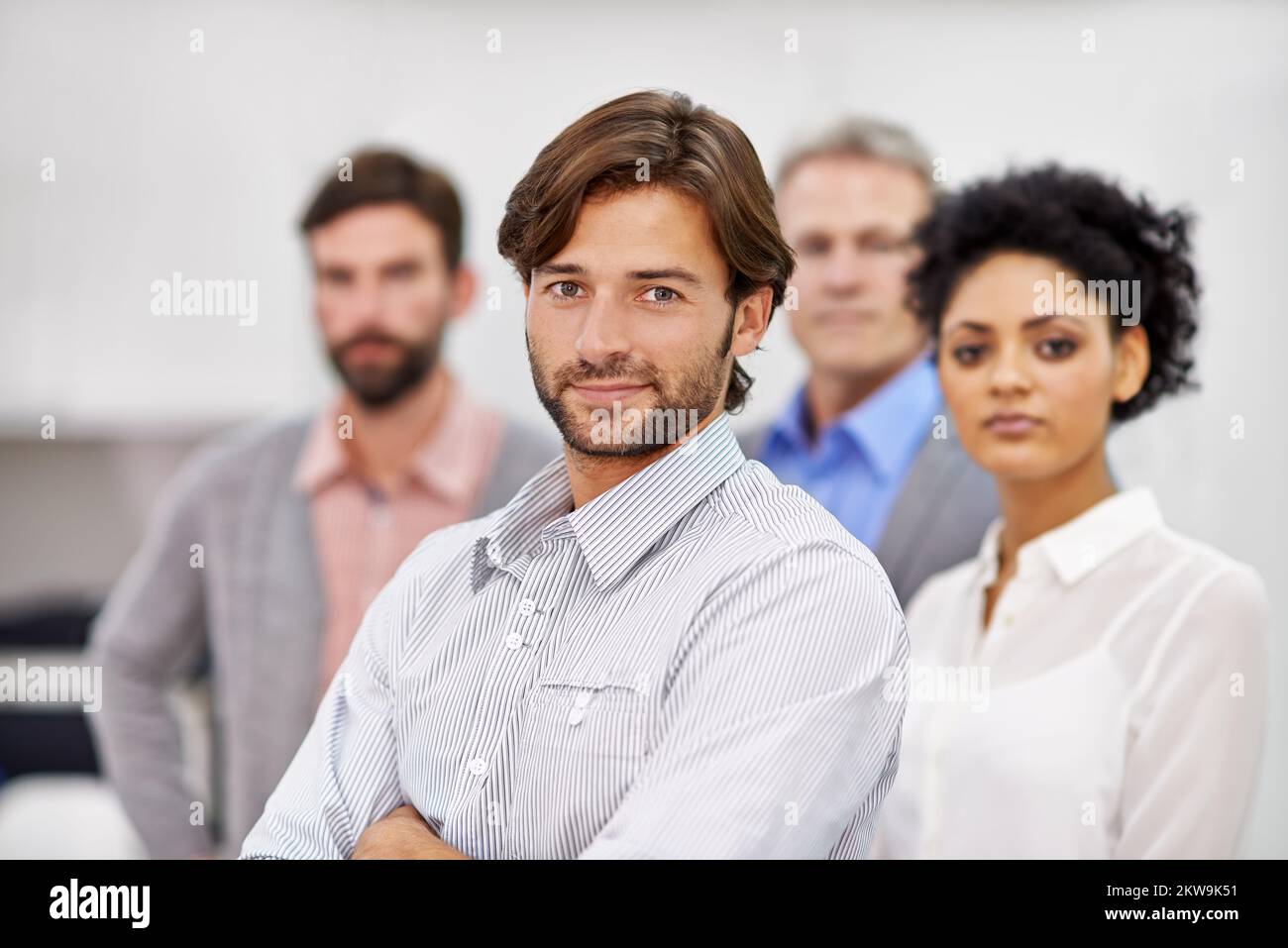 Confident in his teamleading abilities. Portrait of a group of young