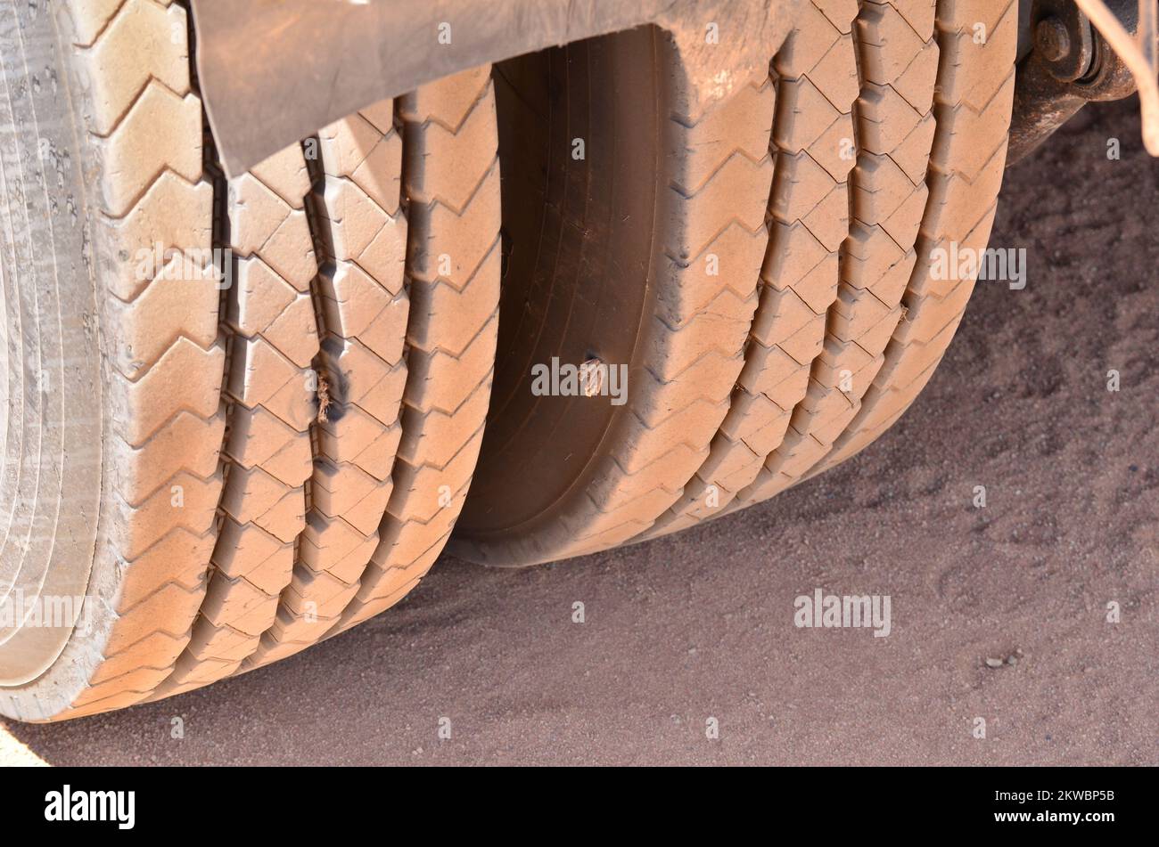 Old Dusty Truck Tire With punkture Repair Hole outside Stock Photo