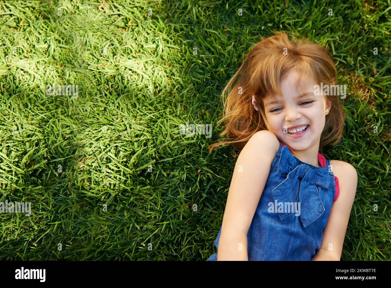 Preteen girl lying on grass hi-res stock photography and images - Alamy