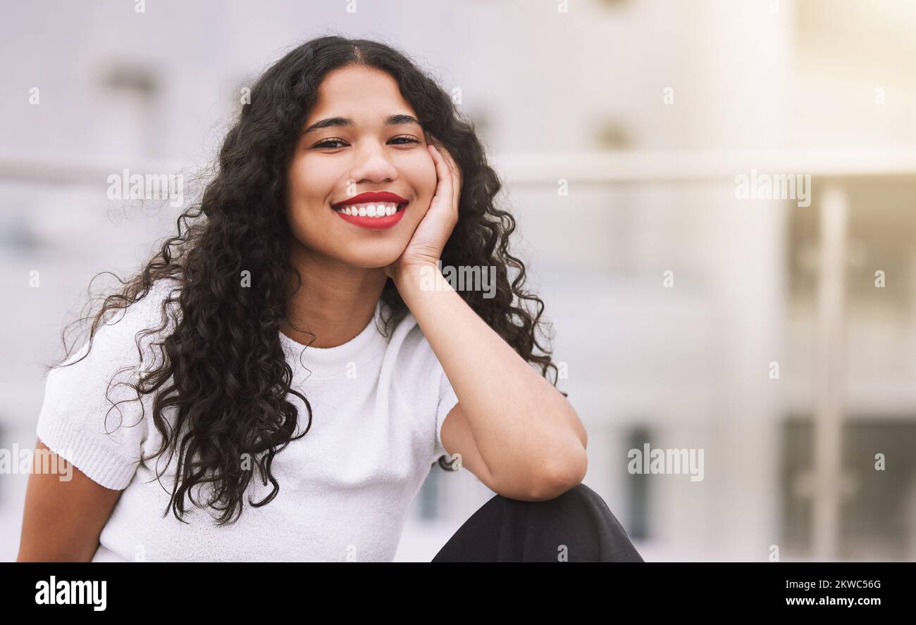 Travel, student and free time with black girl in a city, relax and happy in summer outdoors. Portrait of a young african female enjoying freedom in Stock Photo