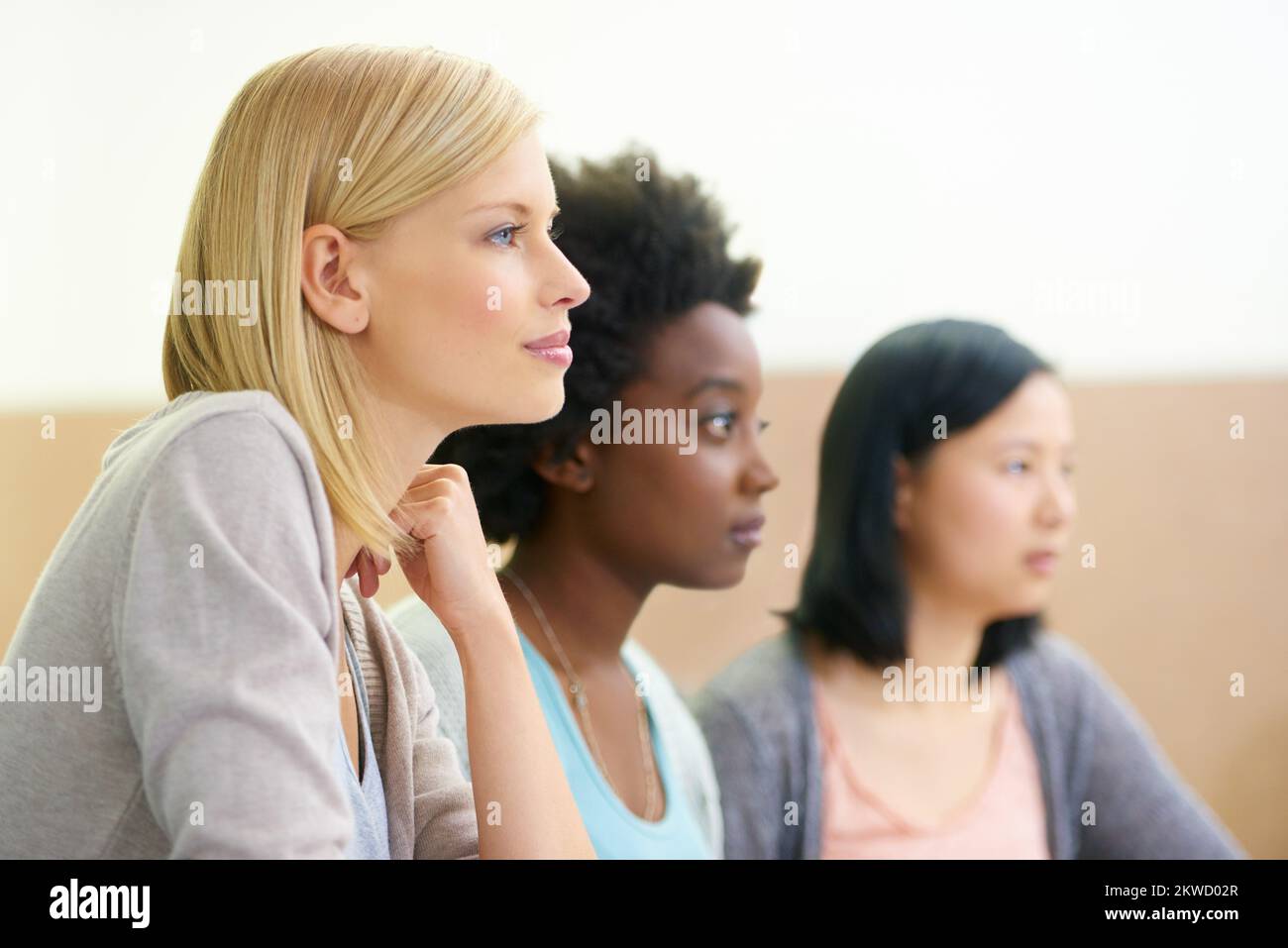 This lecture is fascinating. female university students sitting in an ...