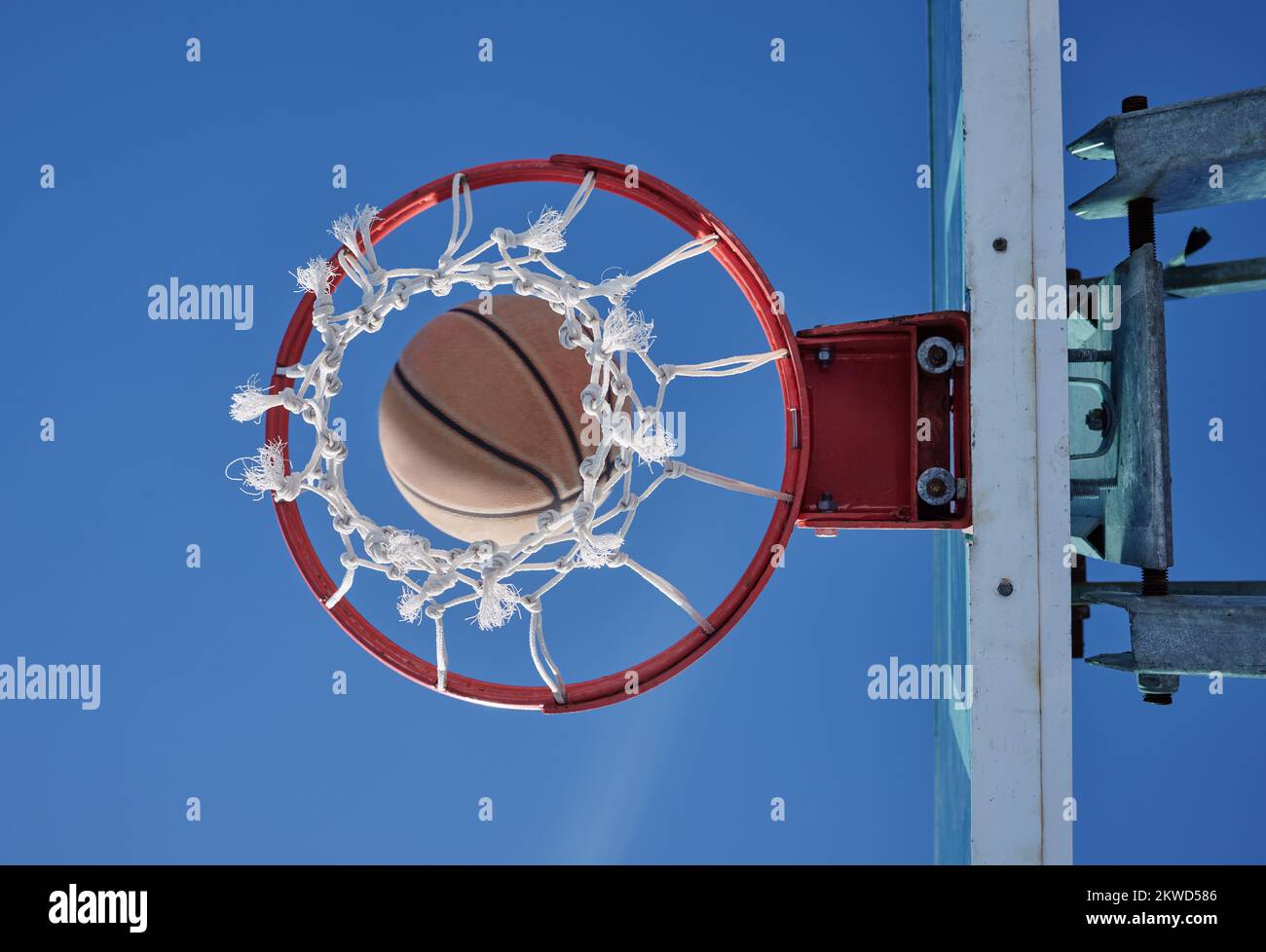 Basketball sports winner throwing, shooting hoops and slam dunk for points, score and performance during sports, competition and game match from below Stock Photo