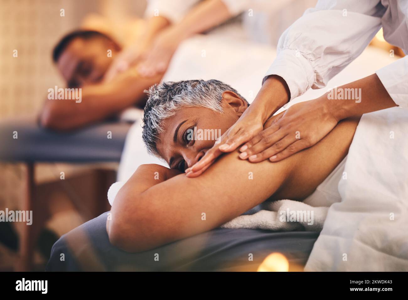 Spa, wellness and black couple getting massage to relax, enjoy romantic holiday, vacation and anniversary. Luxury treatment, beauty salon and senior Stock Photo