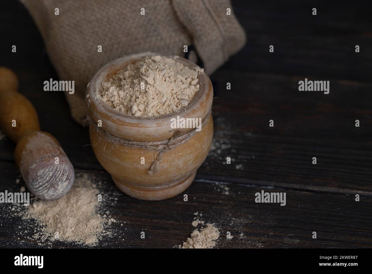 Gofio, Canarian flour  in wood mortar  on wooden background . This is important ingredient of many dish of Canary Islands Cuisine. Stock Photo