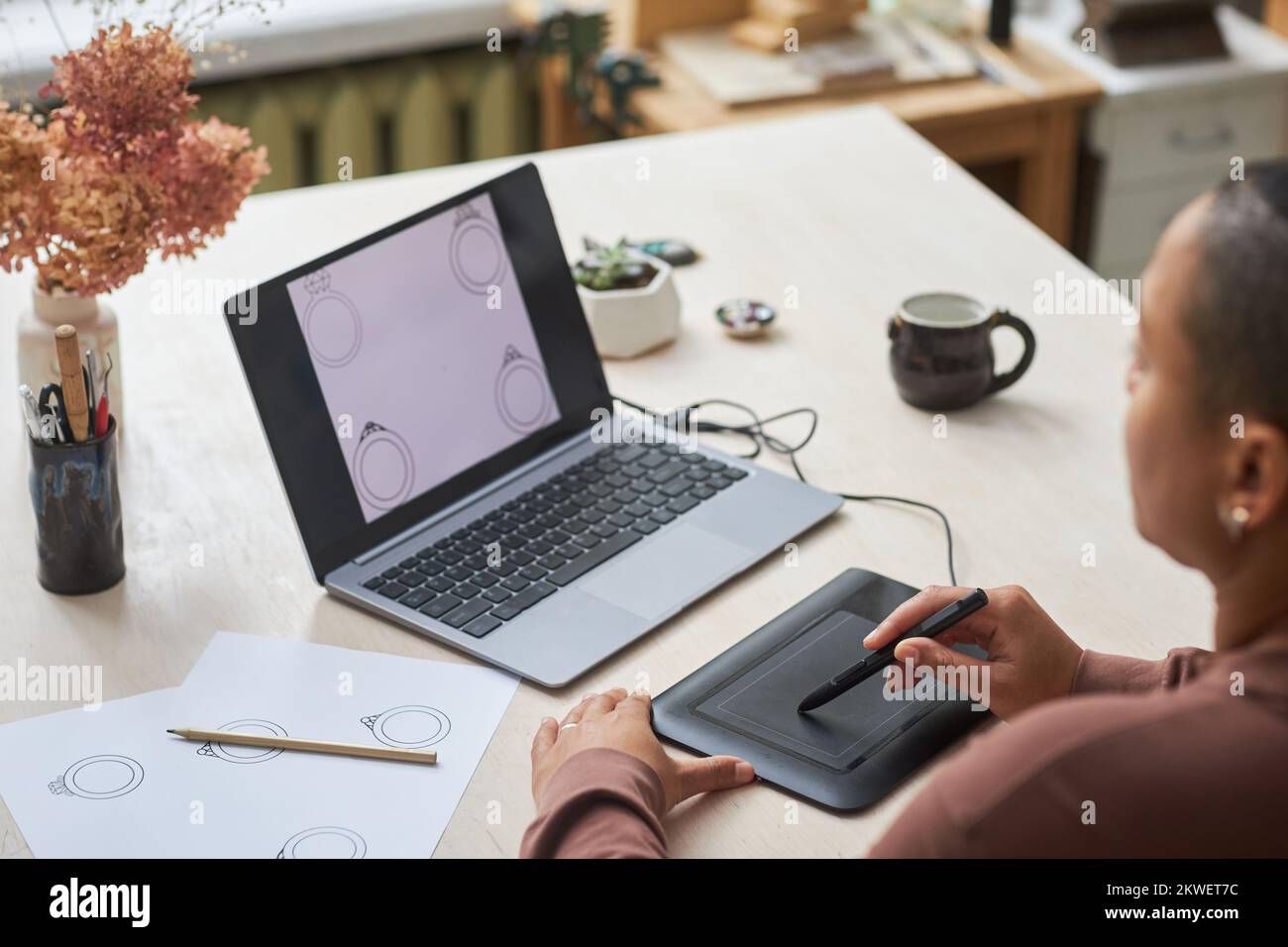 Person Using Graphics Tablet Closeup of female artist using graphic tablet while designing jewelry ...