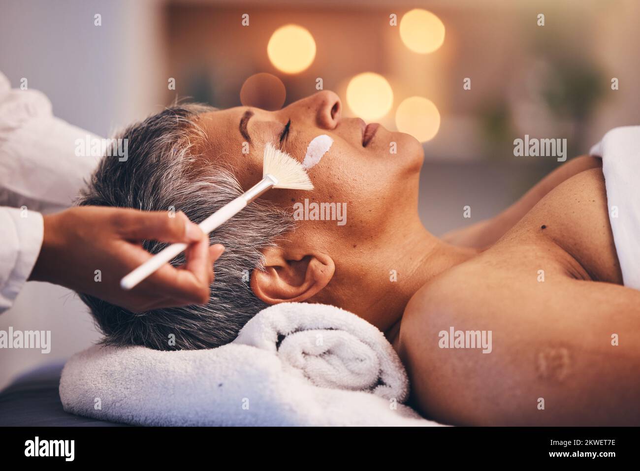 Spa, facial and senior black woman with mask for skincare, beauty and luxury treatment at beauty salon. Wellness, face massage and mature female relax Stock Photo