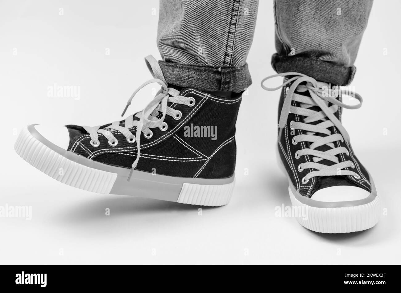 Gym shoes on female legs on a white background, isolate. Female legs in