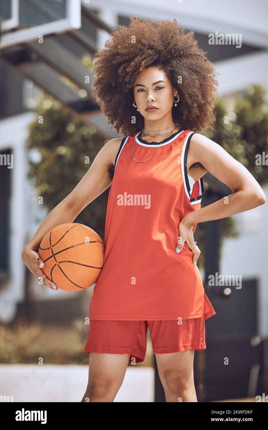Basketball court, woman player or sports person with afro looking serious at training, workout and exercise or competition ball game. Fitness portrait Stock Photo