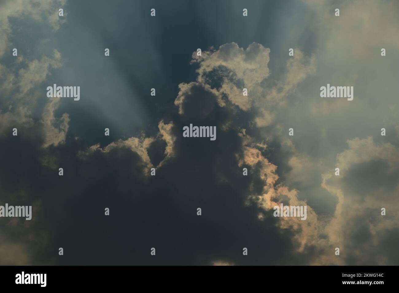 Rays of light shining through dark clouds for background Stock Photo