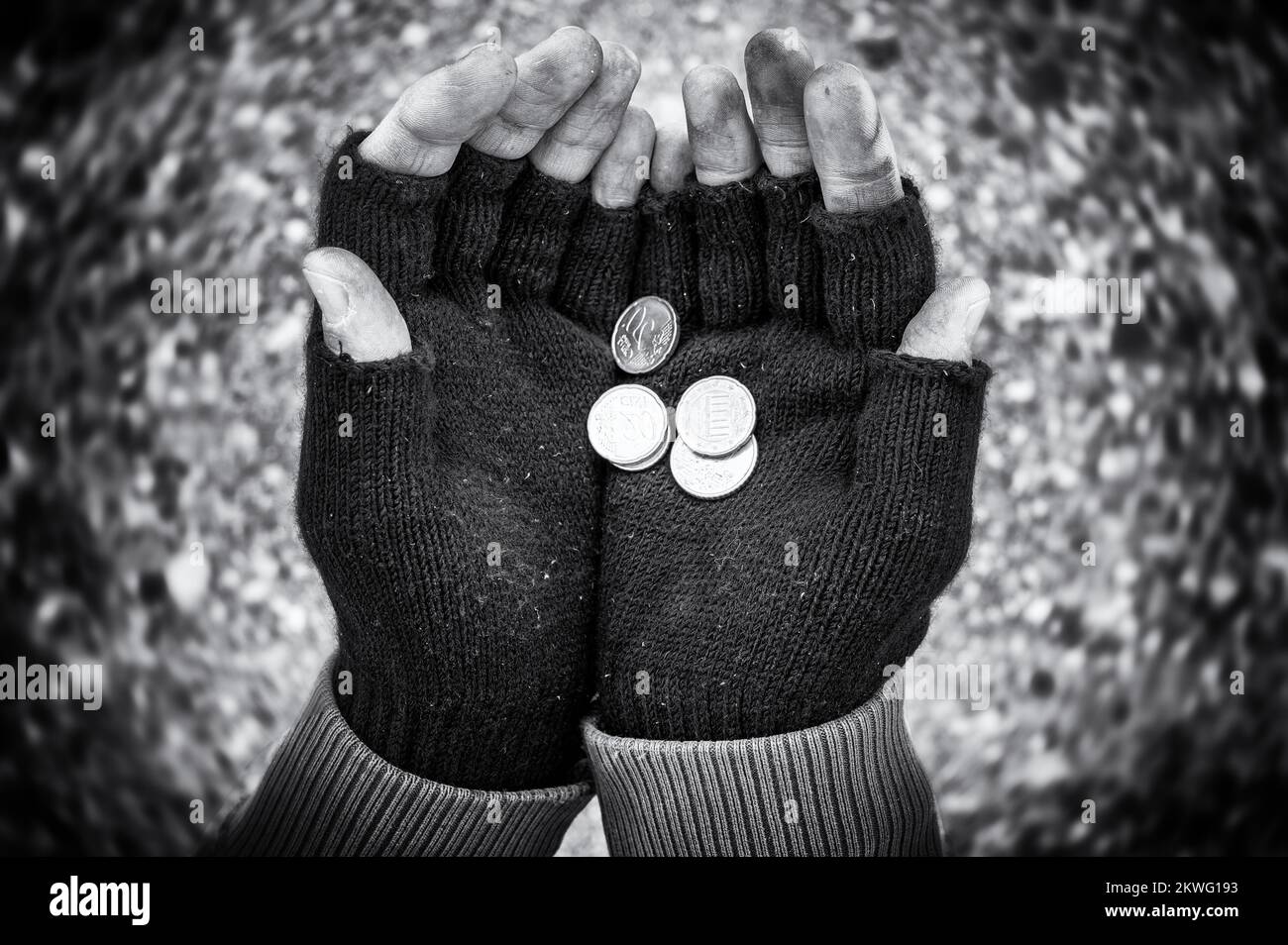 Begging hands with small change as a symbol of poverty and suffering Stock Photo