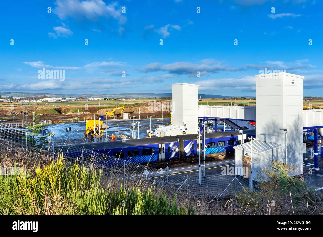 Inverness Airport Railway Station a Scotrail train standing at the new station and  the airport in the distance Stock Photo