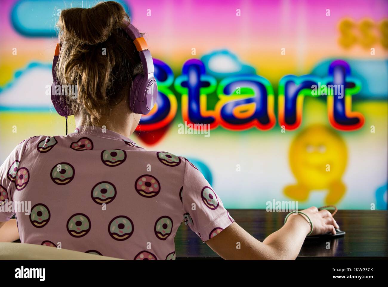 A child or teenager is playing computer video games on a large screen. Online video game