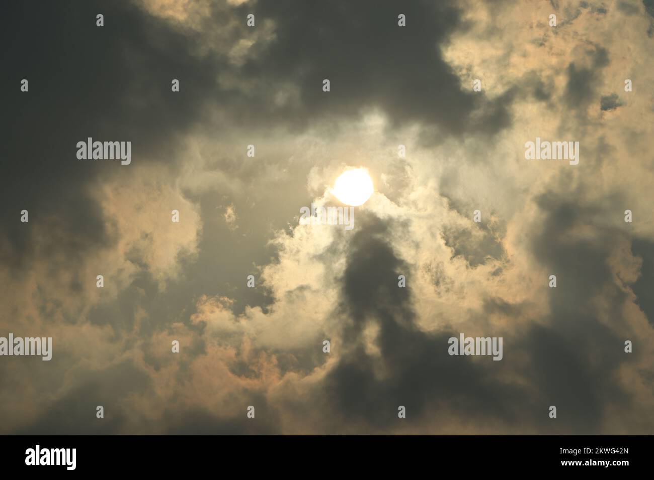 Rays of light shining through dark clouds for background Stock Photo