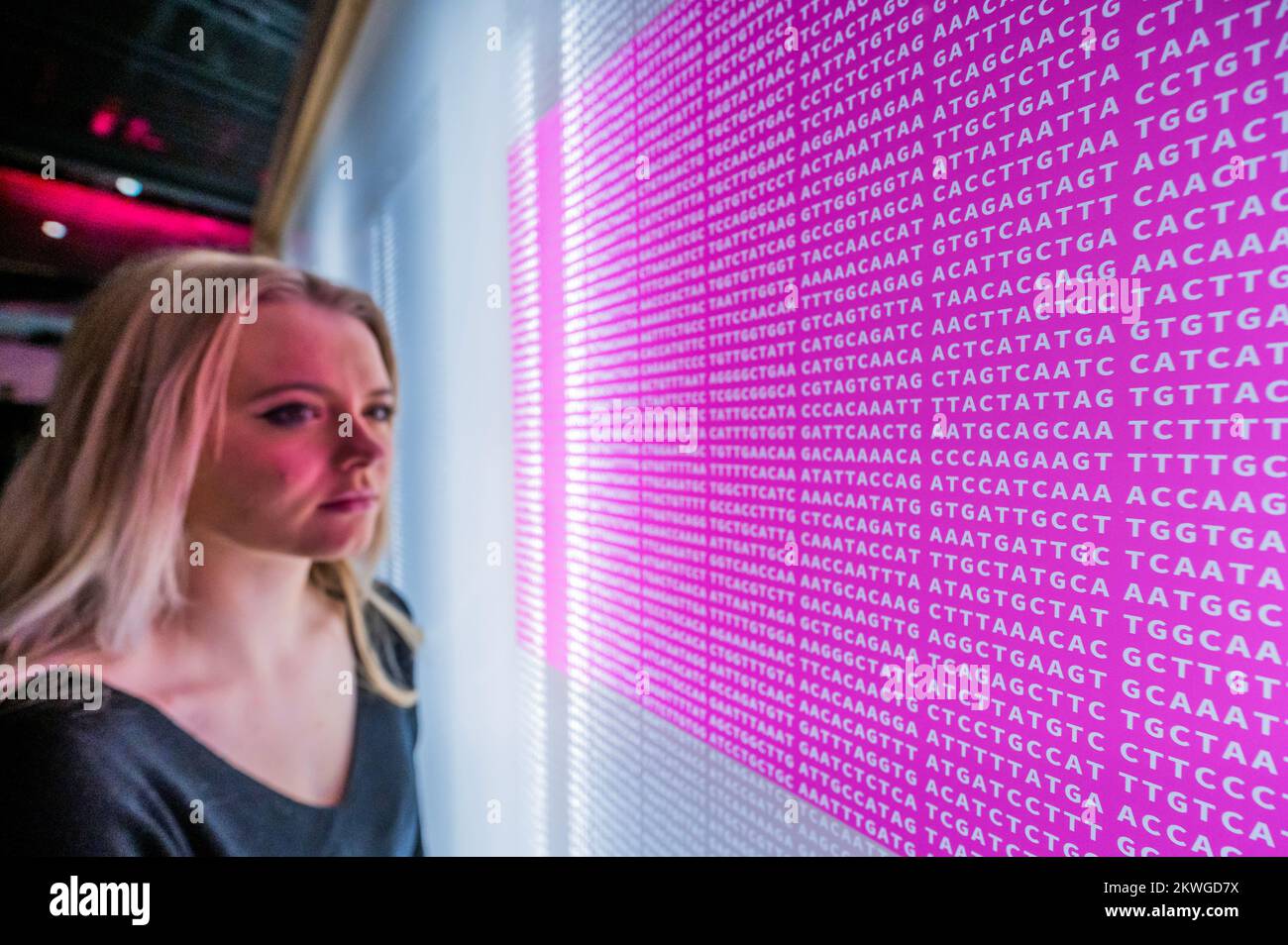 London, UK. 30 Nov 2022. Genetic code for the virus that causes COVID-19, highlighted in pink is the sequence responsible for producing the spike protein - Injecting Hope: The race for a COVID-19 vaccine, a new exhibition at the Science Museum. It explores the worldwide effort to develop vaccines. It aims make the invisible visible: from examining the virus itself to revealing the work that made the vaccines possible. Including pieces by artists Angela Palmer and Junko Mori which help visitors to visualise the virus. Over 100 objects illustrate the response to curb its impact. Credit: Guy Bell Stock Photo