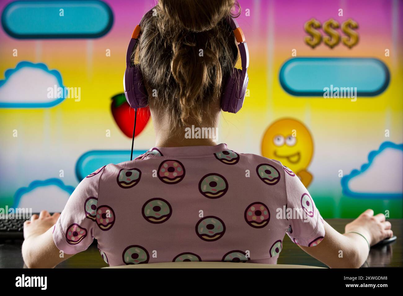 A child or teenager is playing computer video games on a large screen. Online video game technology and teen gaming addiction Stock Photo