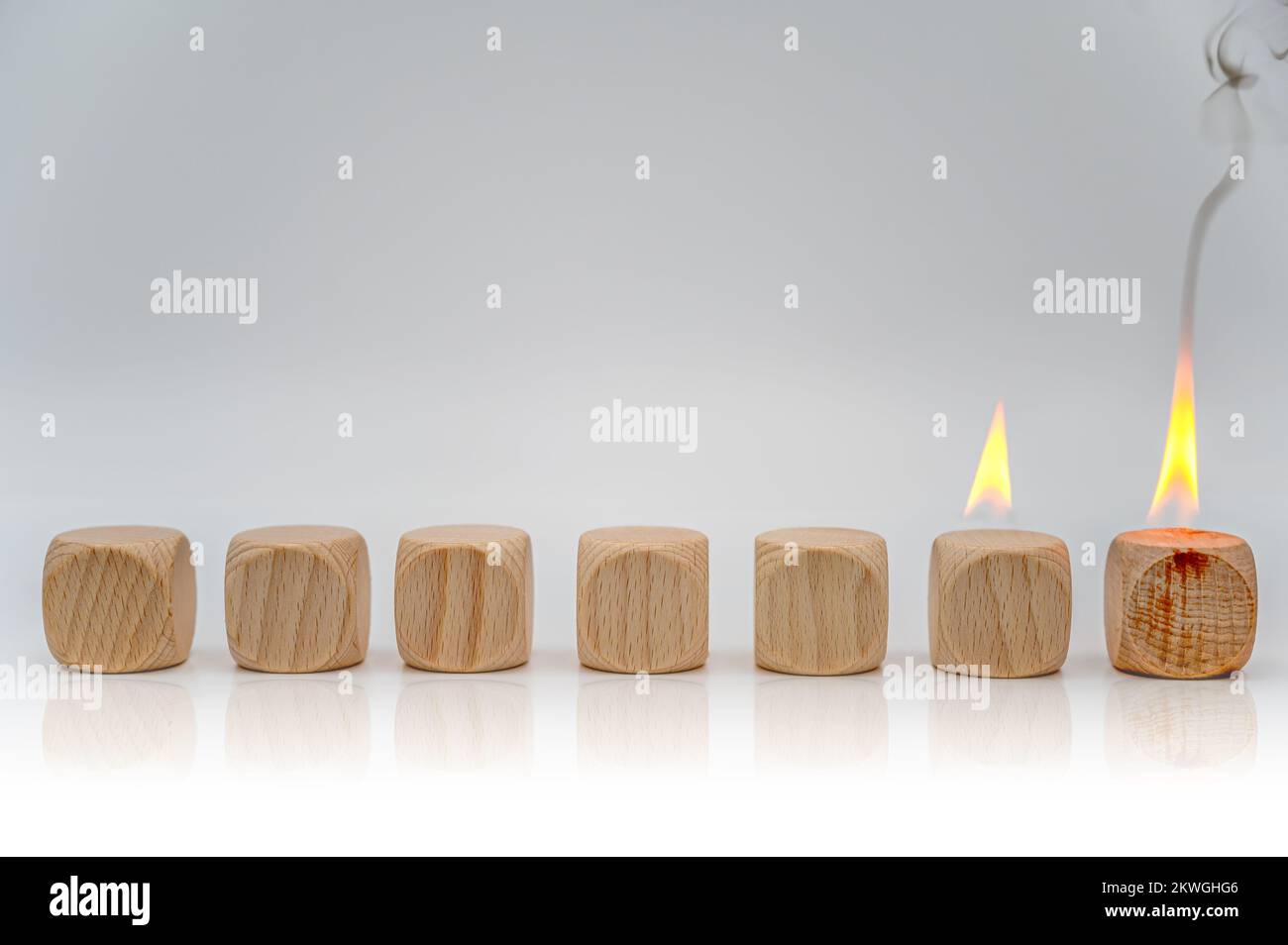Seven cubes, two of them are on fire as a template for individual adjustments Stock Photo