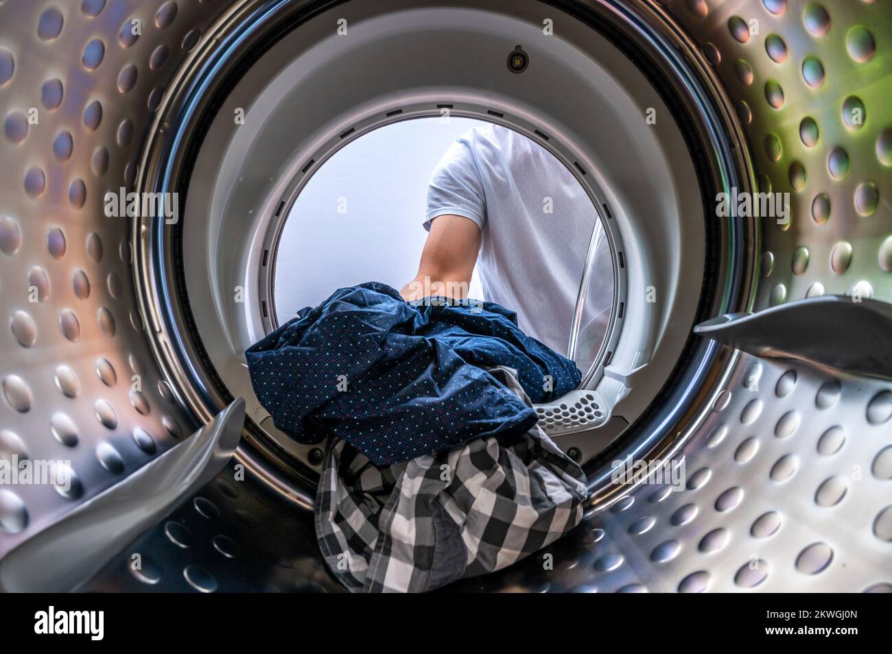 View from a washing machine when loading the washing drum with laundry Stock Photo