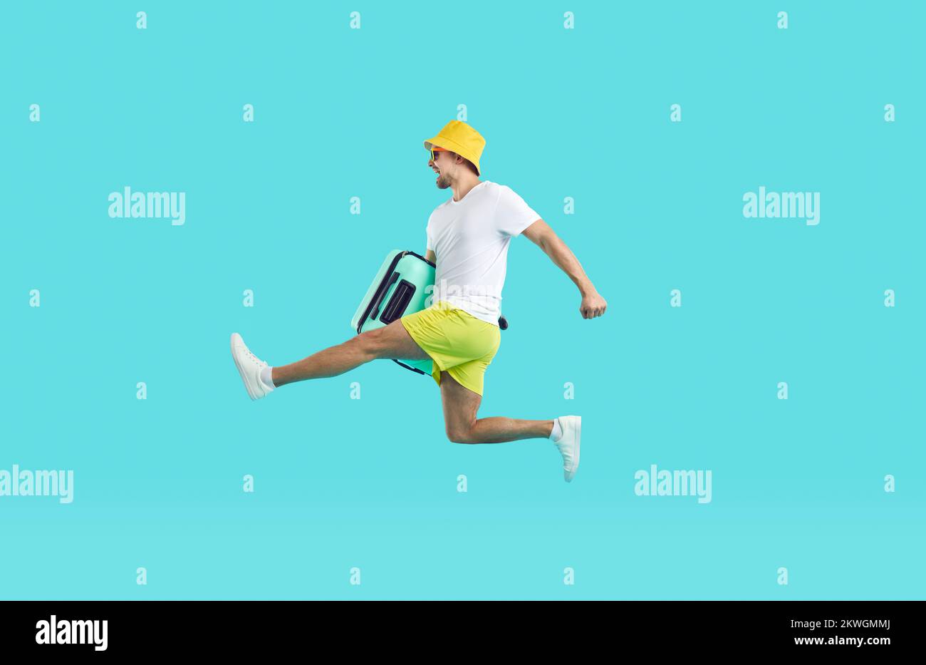 Excited man with suitcase jump into summer vacations Stock Photo