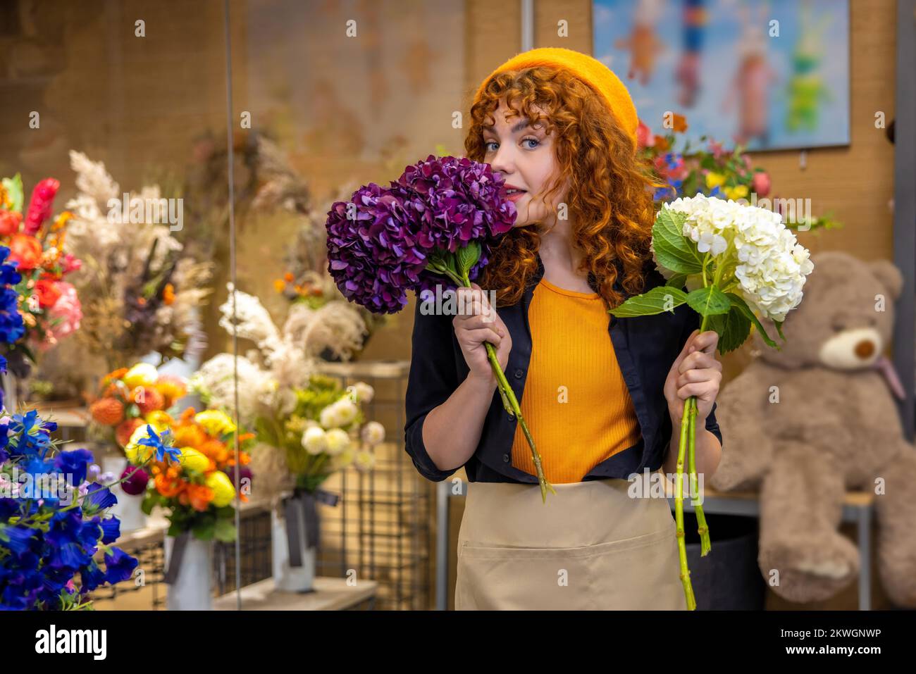 Ginger cute girl in a flower shop Stock Photo Alamy