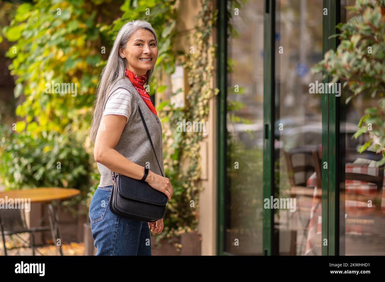 Well-dressed woman looking contented and smiling Stock Photo