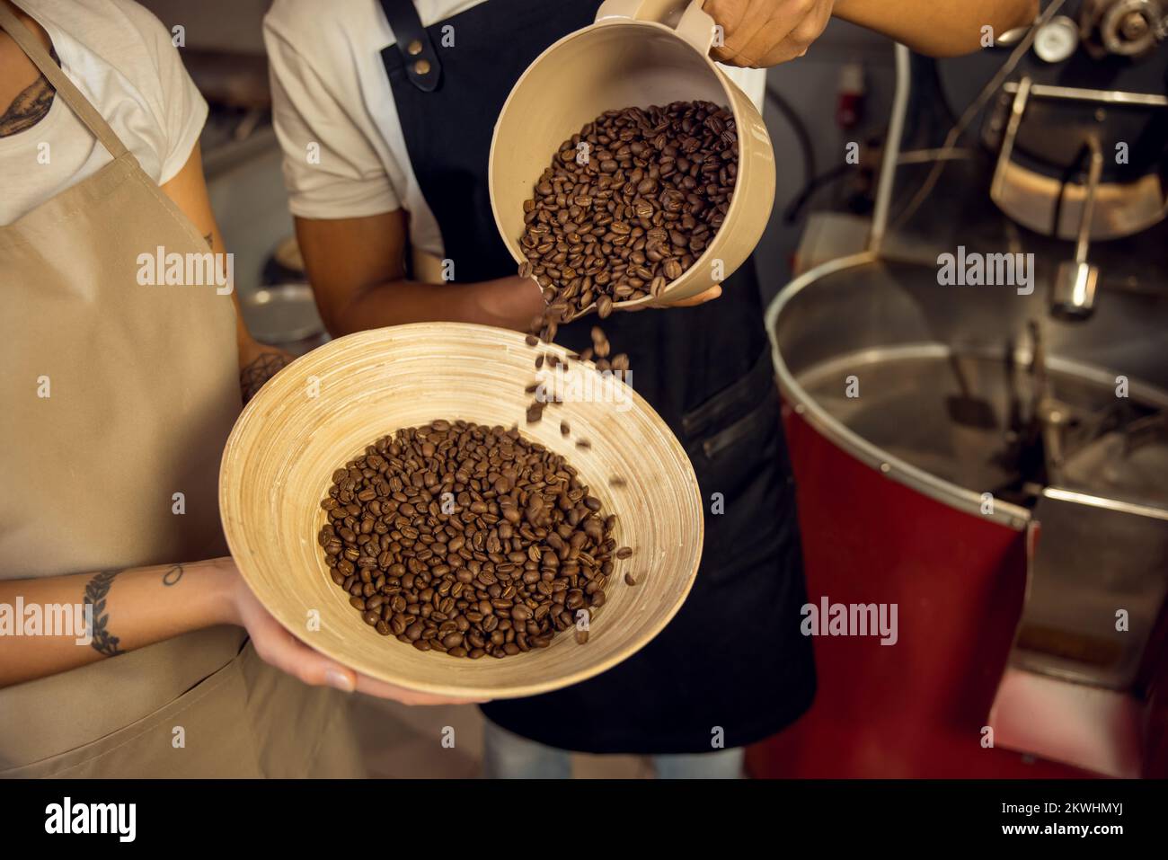 Roast masters in the aprons involved in coffee sorting Stock Photo Alamy