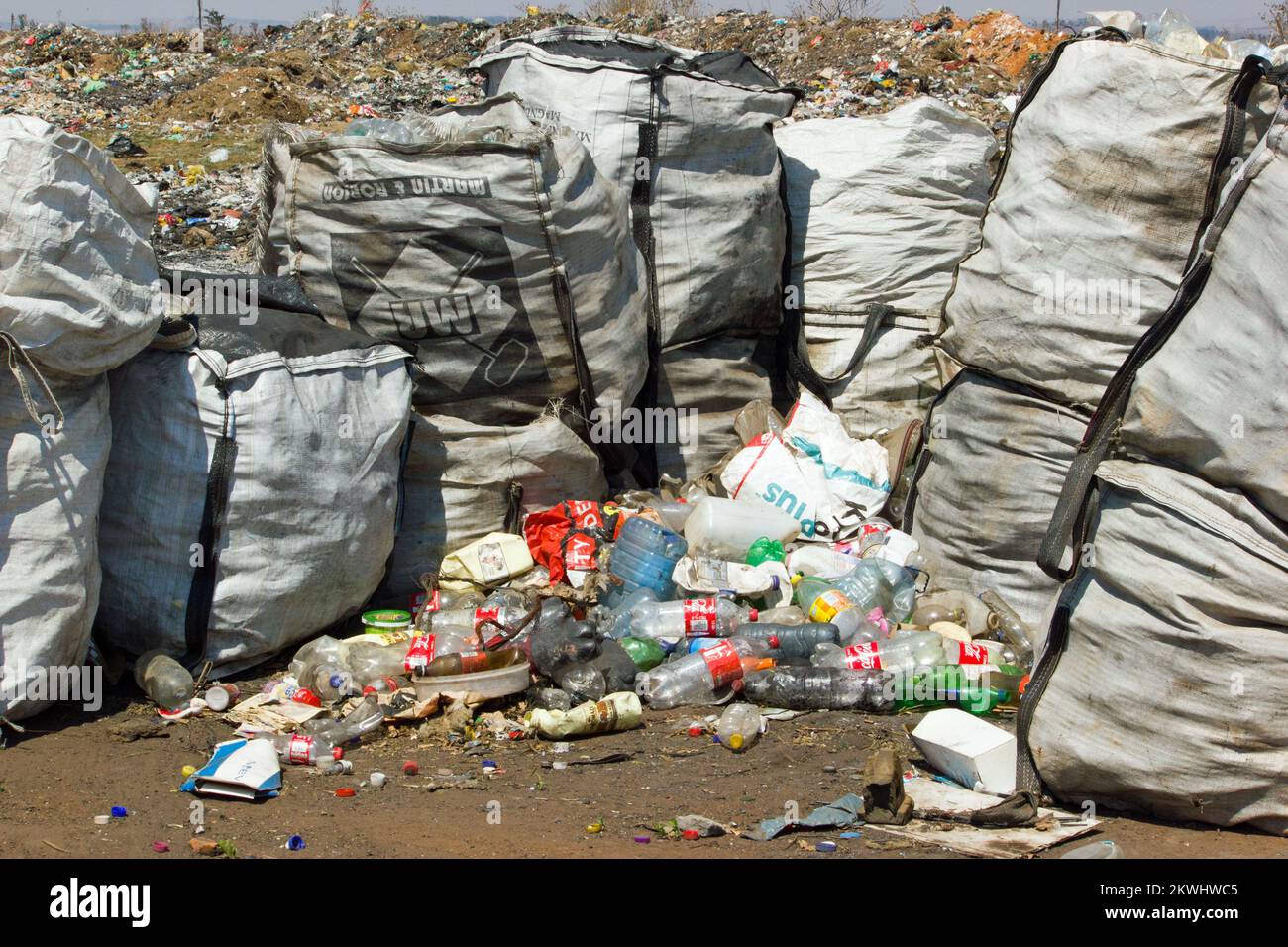 stock photo of garbage collection bags and empty plastic bottles on