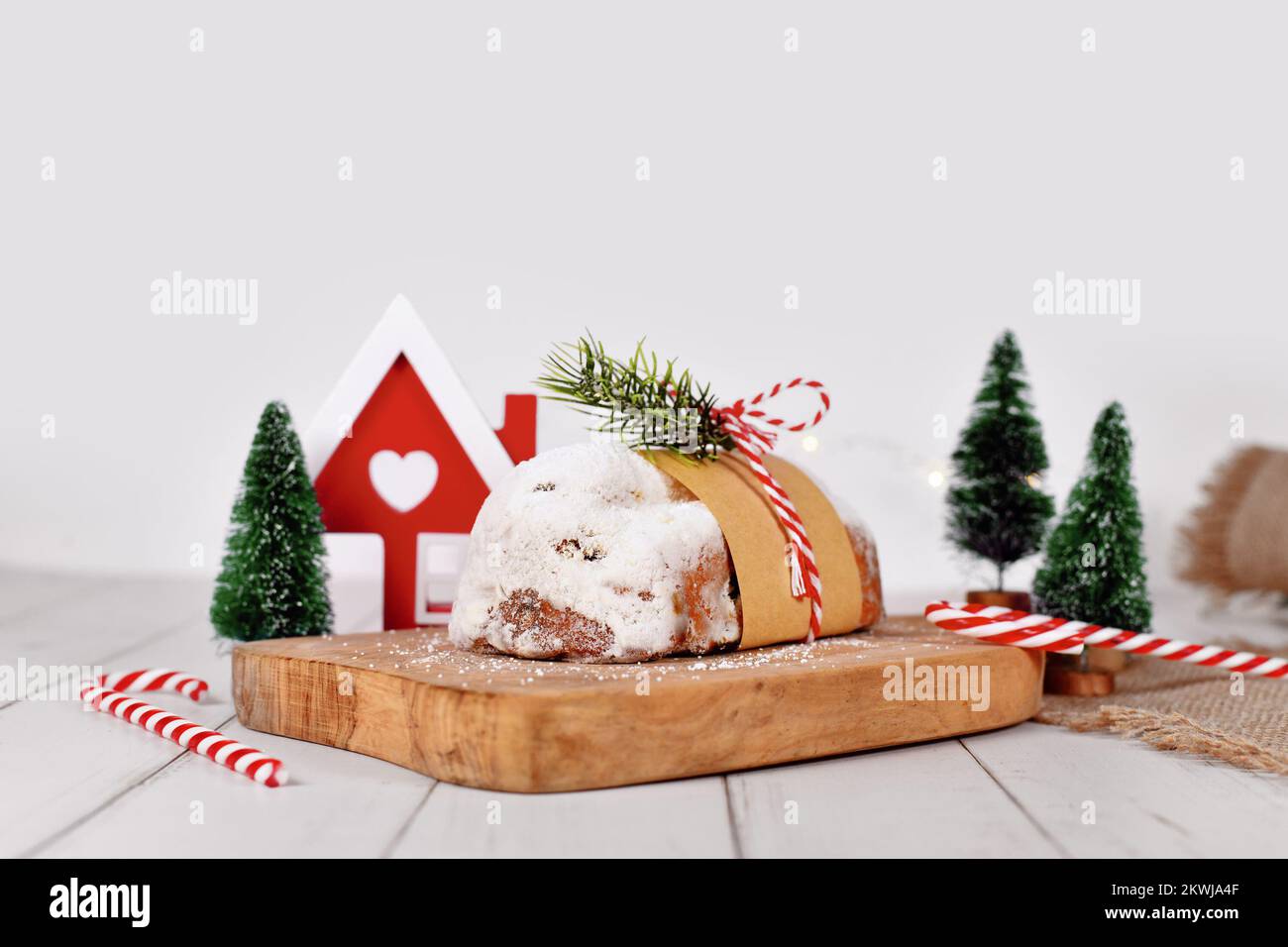Whole traditional German Stollen cake, a fruit bread with nuts, spices, and dried fruits with powdered sugar, served during Christmas time Stock Photo