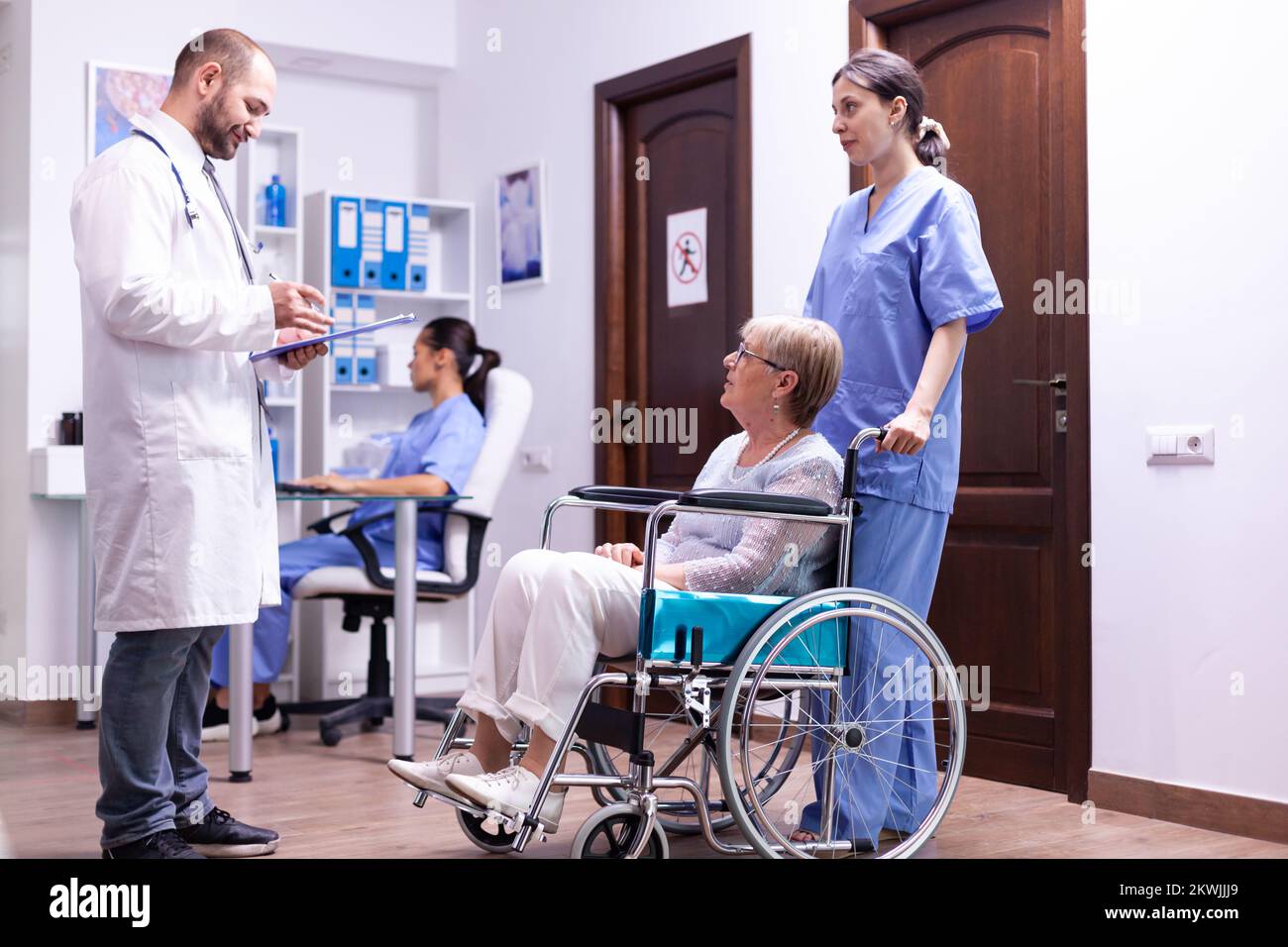 Doctor checking diagnosis of disabled senior woman in wheelchair