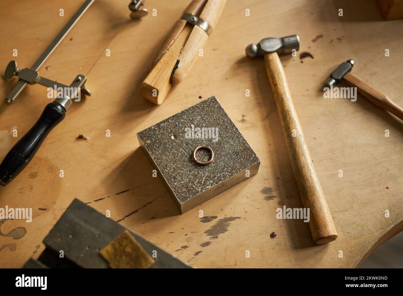Closeup background image of rustic jewelers workstation with tools and ring on wooden table, copy space Stock Photo