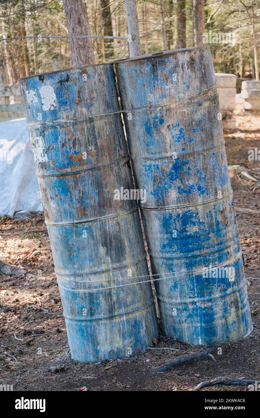 Metal barrels in the forest during the game, cover and shelter in