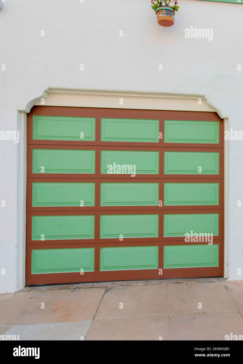 Vertical Two garage doors with brown grid lines and green panels at La