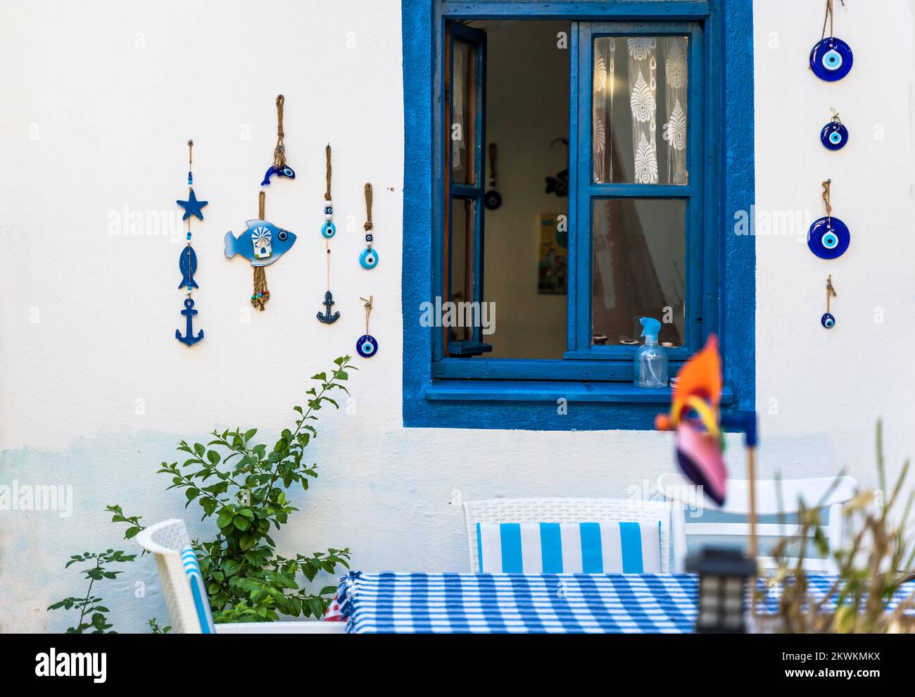 Turkish cafe in mediterranean greek style with a blue window and a table for dinner, decorated with beautiful Turkish national decorations. High quality photo Stock Photo