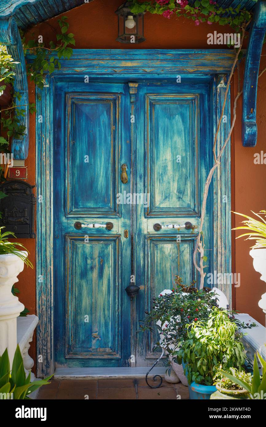 Beautiful blue door of a street cafe decorated with decor and flowers with plants. High quality photo Stock Photo