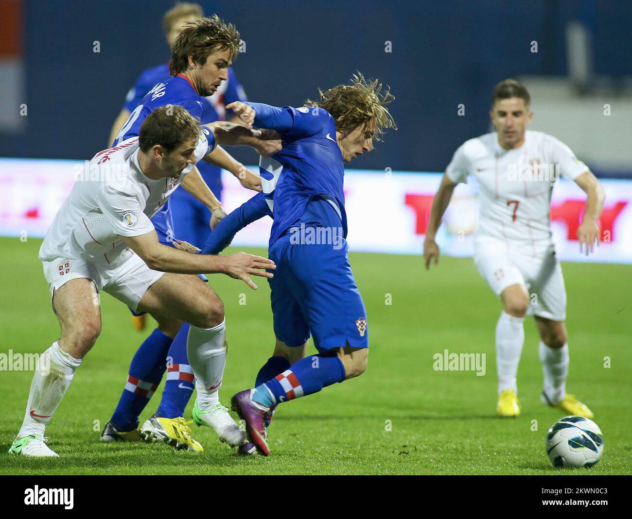 Niko Kranjcar and Luka Modric battle for the ball in the 2014 World Cup qualifier between Croatia and Serbia at Maksmir Stadium in Croatia. Stock Photo