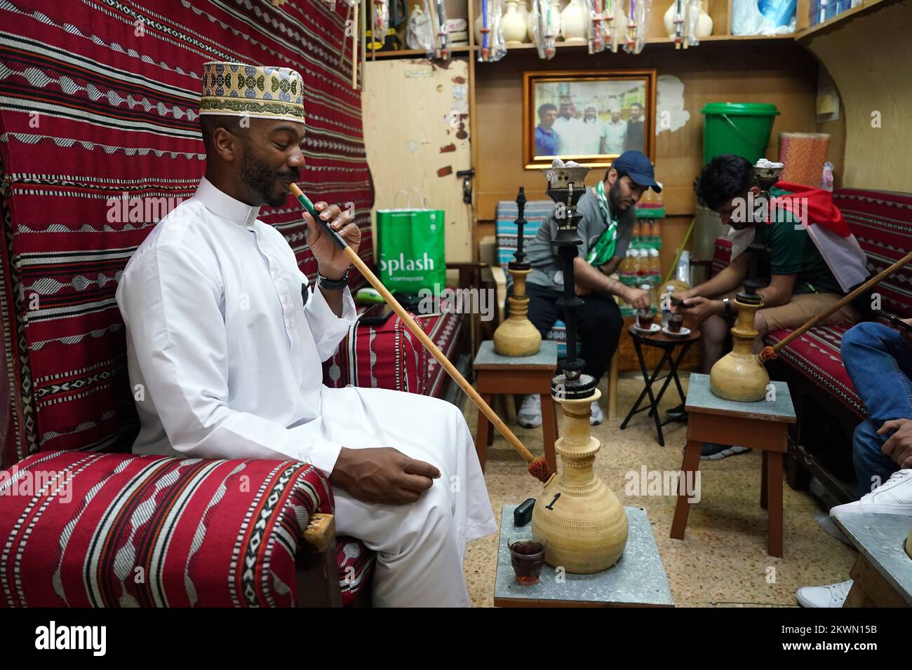 Local residents smoking hookah pipes in the Souq area of Doha. Picture