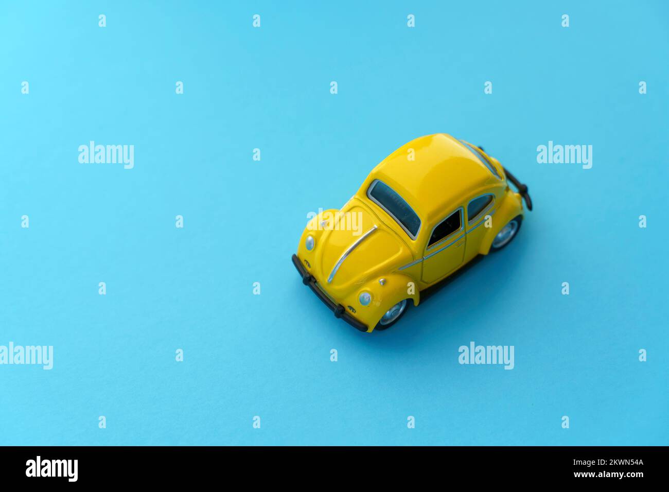Travel car concept background. Yellow toy car on empty minimal pastel background. Driving, riding, road idea. High quality photo Stock Photo