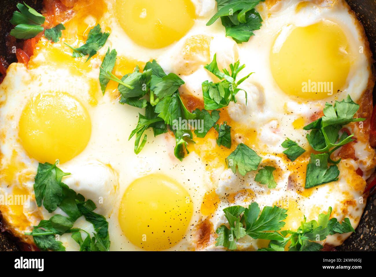 Shakshuka eggs close up. Poached eggs in a spicy tomato and pepper