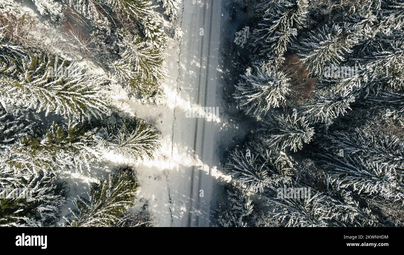 Aerial view of snowy forest with winter mountain road Stock Photo - Alamy