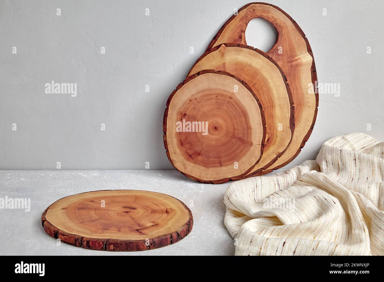 Kitchen space with wooden cutting boards and tea towel on a light