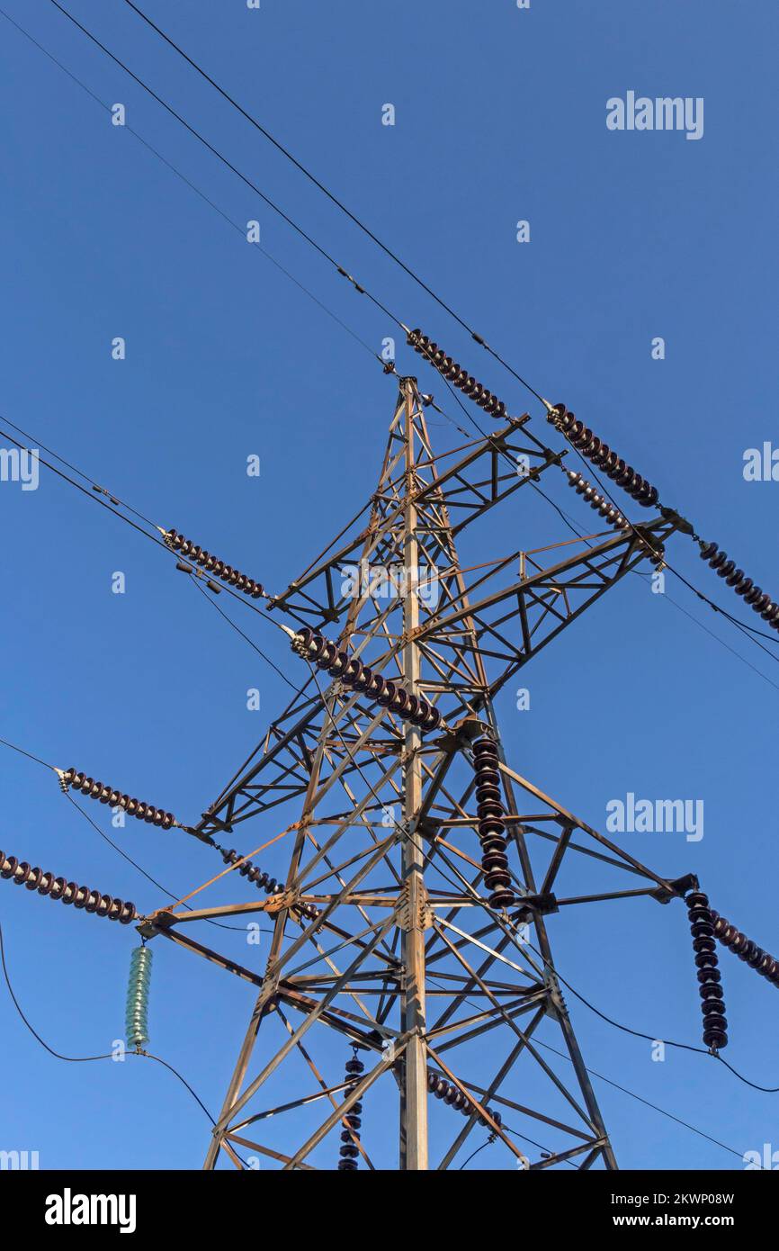 close up of wires and electricity pylon against blue sky Stock Photo