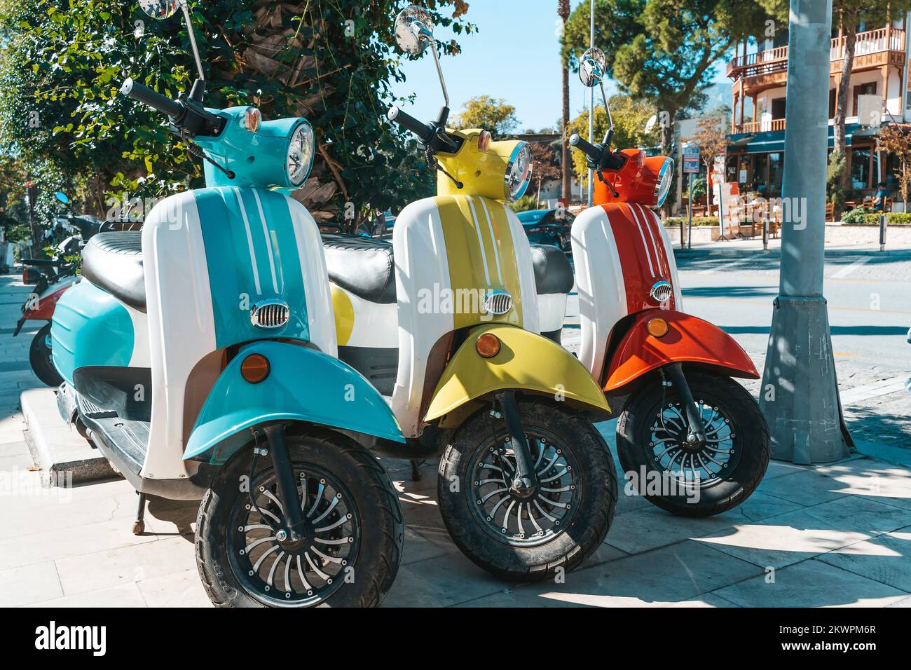 Scooter motorcycle on city street. Vintage classic retro scooters various bright colors on a sunny tourist street. Lifestyle, retro concept. High quality photo Stock Photo