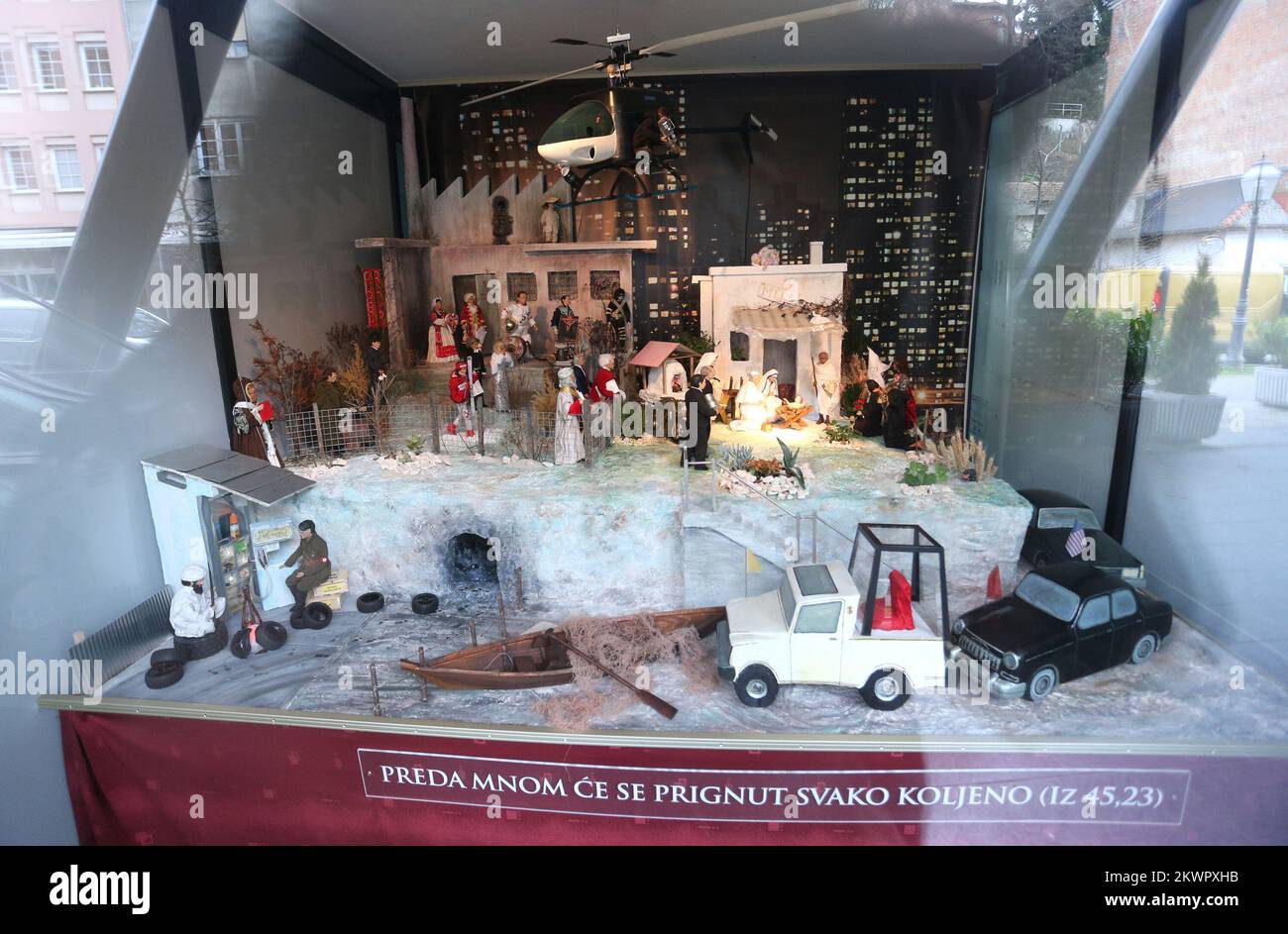 30.12.2013., Crotia, Zagreb - Nativity scene with famous figures in one of the shop windows in downtown Cascade Tkalciceva street below which says: In front of me shall bow every knee (from 45.23). Nativity scene made by a priest Mijo Gabric, a little Jesus was visited by Mother Teresa, Gandhi, Franjo Tudjman, Tito, Janica Kostelic, Osama Bin Laden, Hitler and other historical figures.  Photo: Sanjin Strukic/PIXSELL Stock Photo