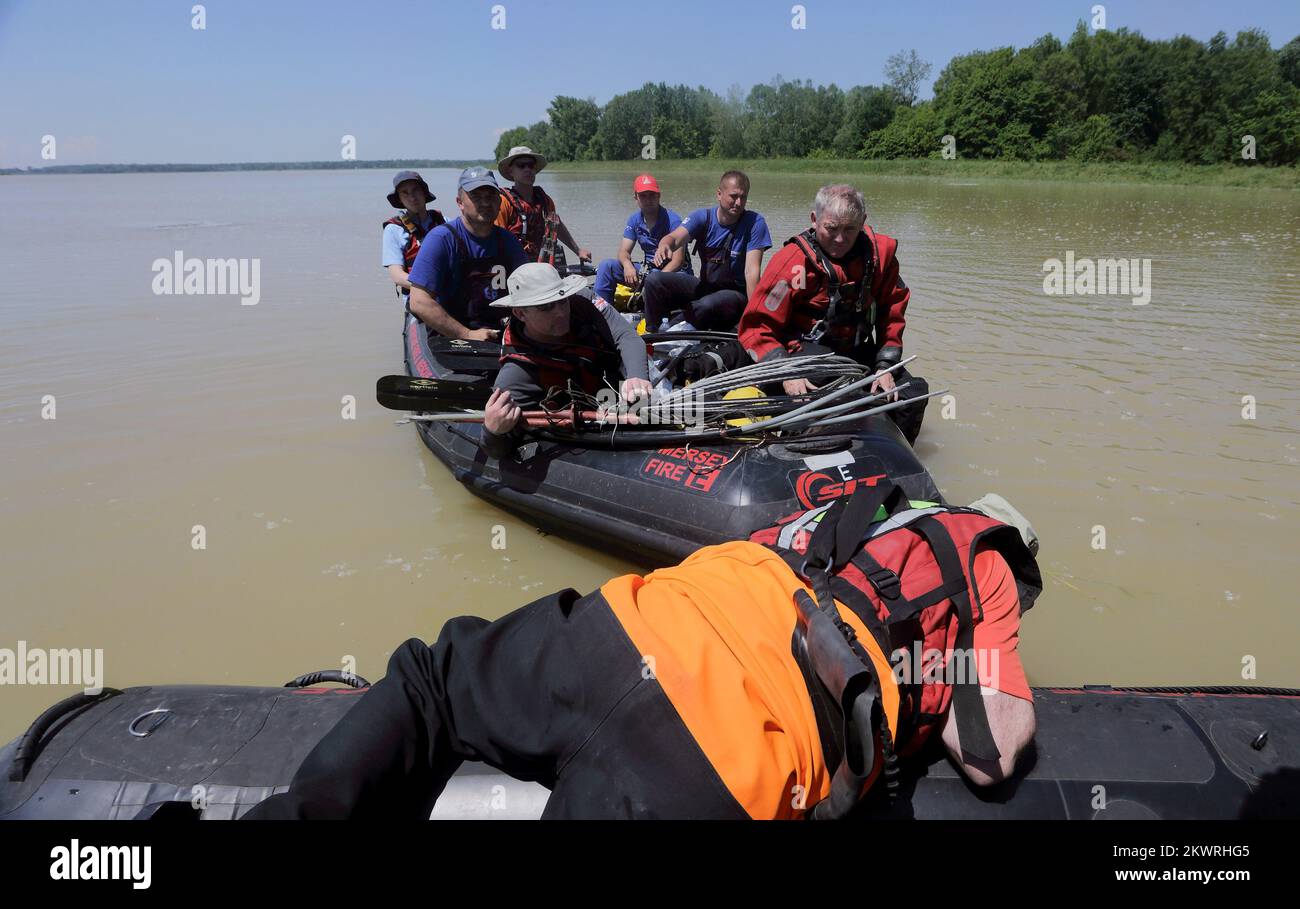 21.05.2014., Bijeljina, Bosnia and Herzegovina - Members of United Kingdom International Search & Rescue Team (UKISAR) have been helping since they arrived on May 18th. UKISAR provides an international search and rescue facility for the UK Government and is on call 24 hours-a-day, 365 days-a-year to respond to an accident or disaster anywhere in the world. They evacuated about 140 people. Today they were all day long driving in boats Elektra workers who were repairing the electricity grid in order to restore power.  Photo: Zeljko Lukunic/PIXSELL  Stock Photo