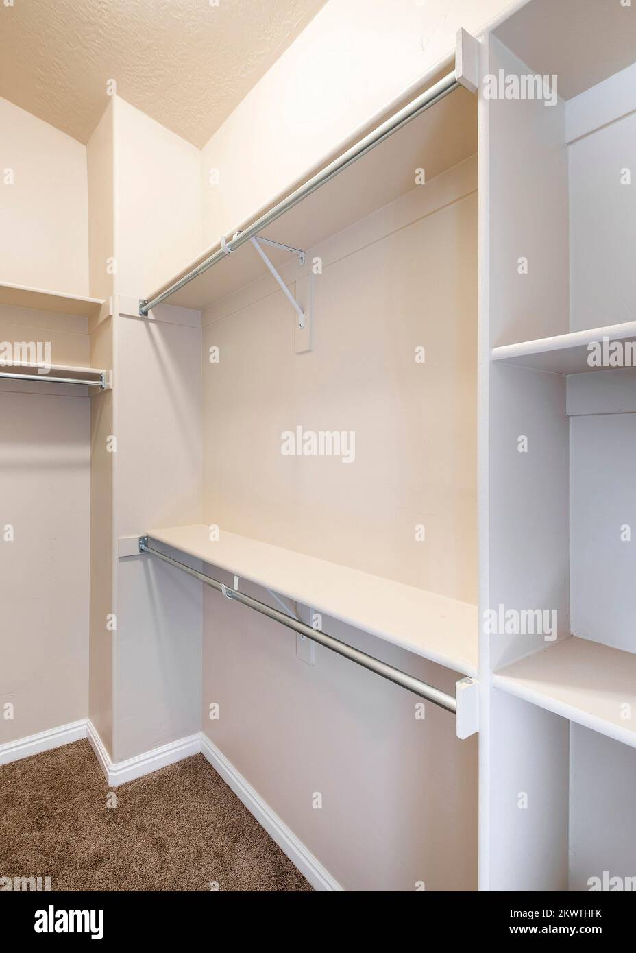 Vertical Narrow windowless walk-in closet with shelves and metal rods ...