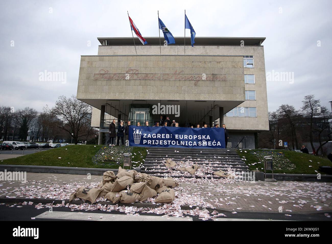 16.12.2016., Croatia, Zagreb - Activists Right for  the City and Green Action carried out a protest action in front of the City Administration, where they arrived with a truck full of bags with fake money,  throwing it by wearing masks with the image of Mayor Milan Bandic with emphasis banner Zagreb: European Capital of garbage. Photo: Goran Stanzl/PIXSELL Stock Photo